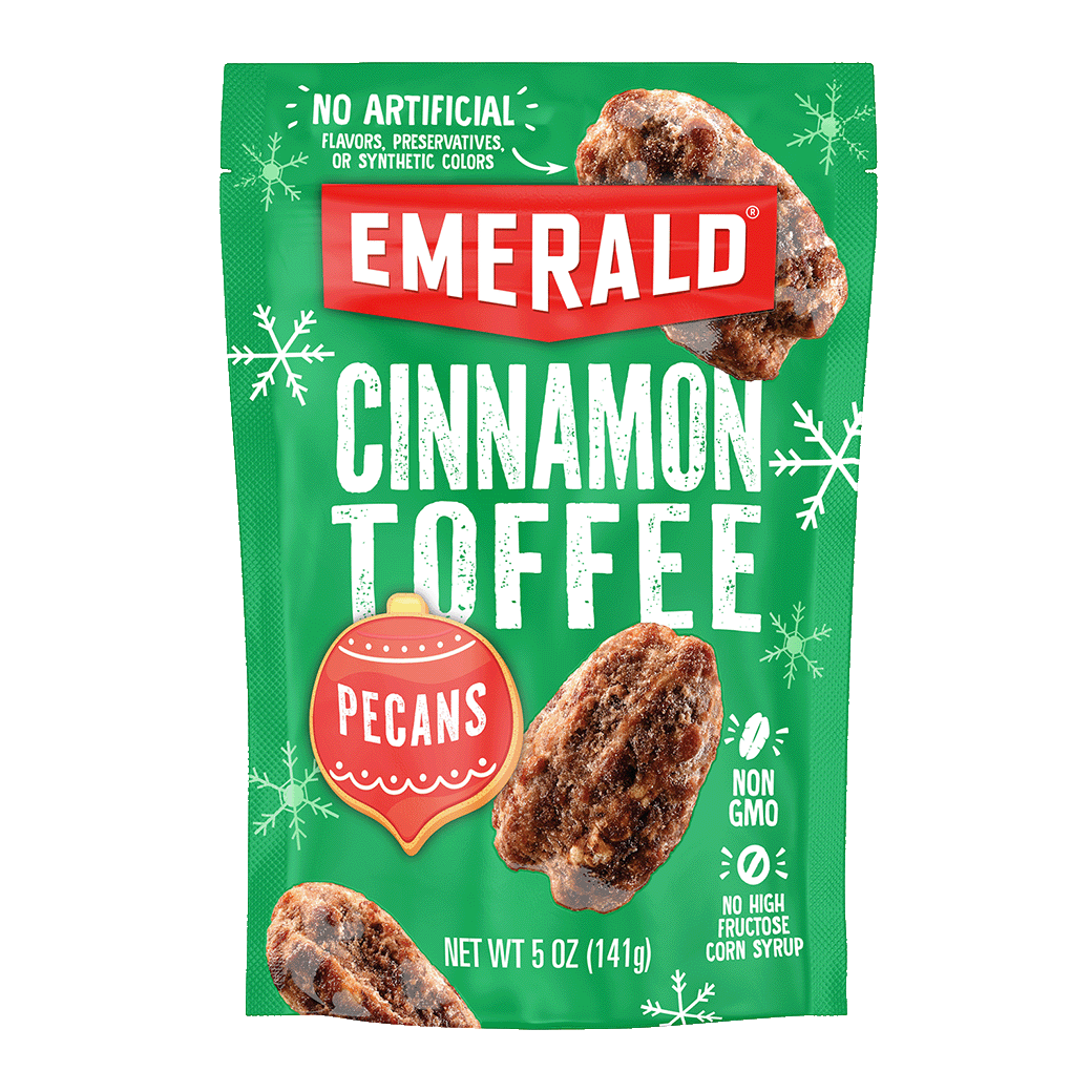 Bright green bag of Emerald Cinnamon Toffee Pecans, 5 oz. Packaging features images of pecans and snowflake graphics. Text includes No Artificial Flavors, Non-GMO, and No High Fructose Corn Syrup.